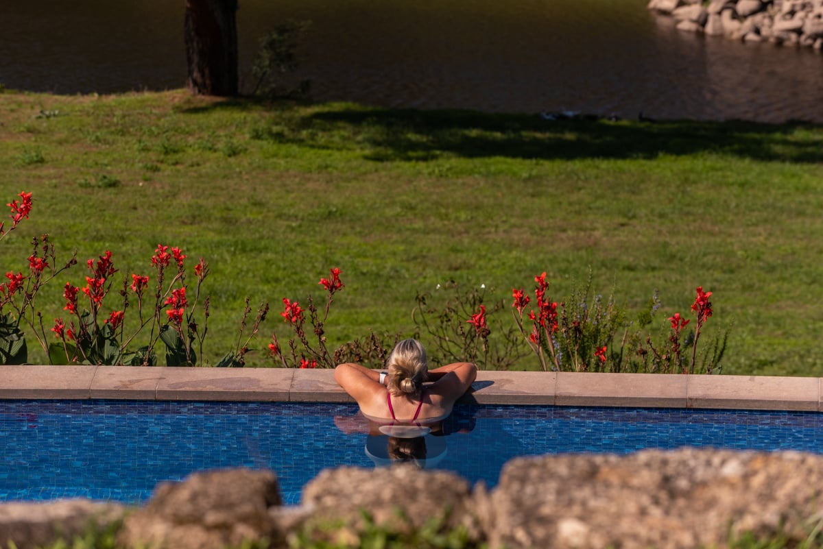 A lady in an outdoor swimming pool